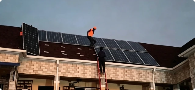 Solar panels being installed on a villa roof