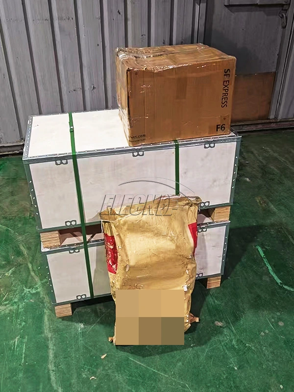 Protective cases, carton and wrapped parcel during Cameroon shipment preparation