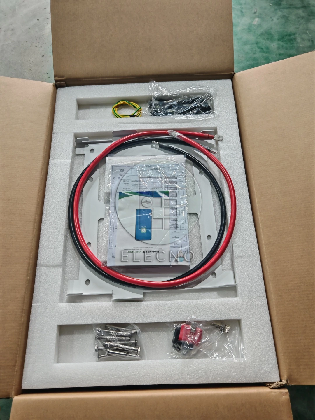 Open carton with protective inserts, battery leads and packaged accessories