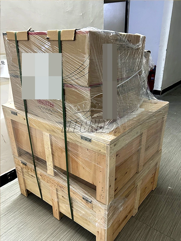 Front view of strapped and wrapped Ghana shipment packaging with customer identifiers obscured