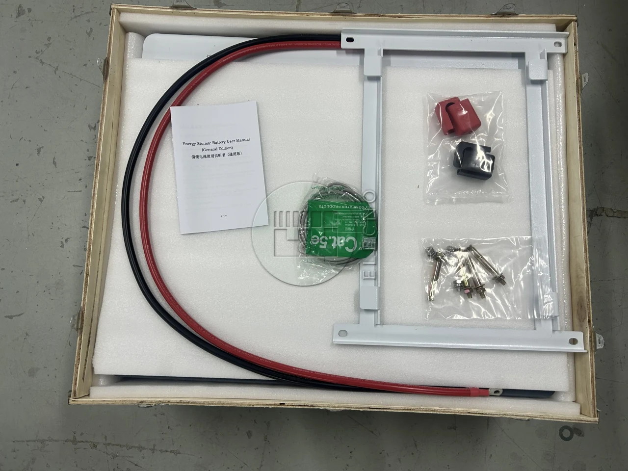 Battery cables and accessories arranged inside protective wooden packaging for Ghana