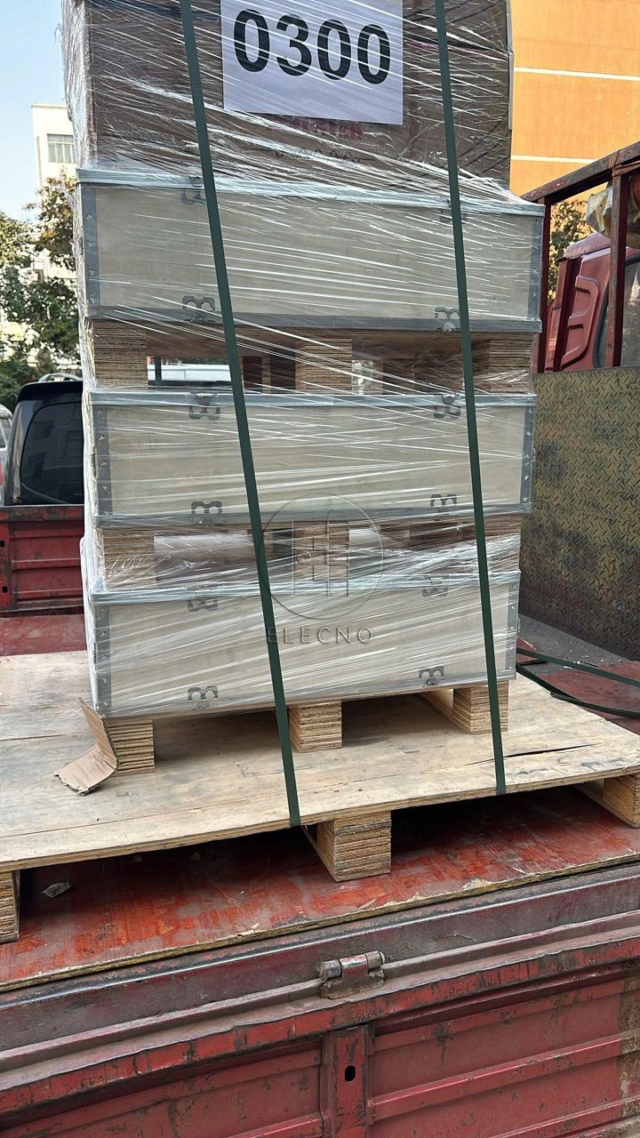 Strapped and wrapped protective battery cases arranged on a wooden pallet