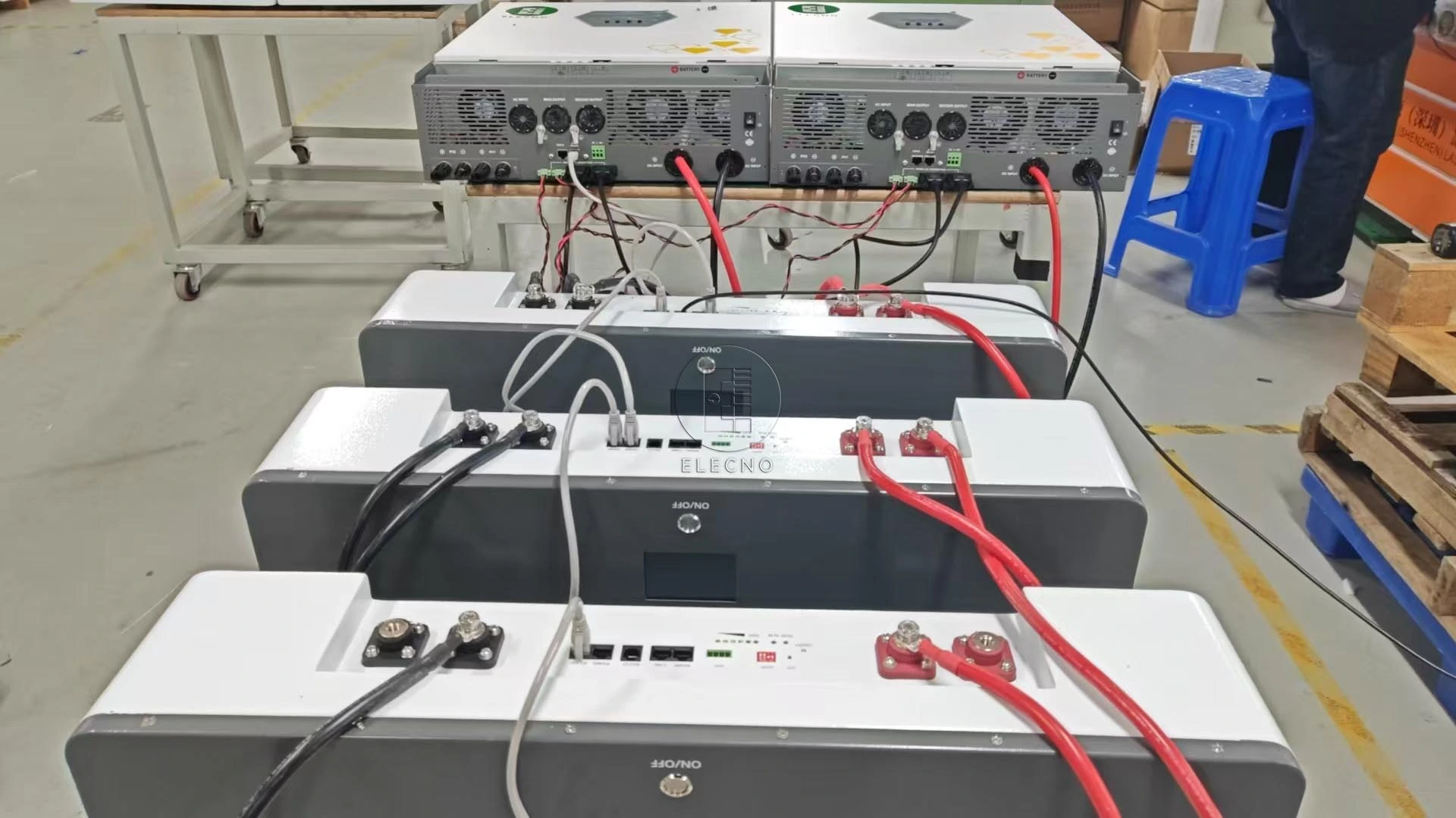 Factory connection arrangement showing three battery enclosures, cables and other equipment