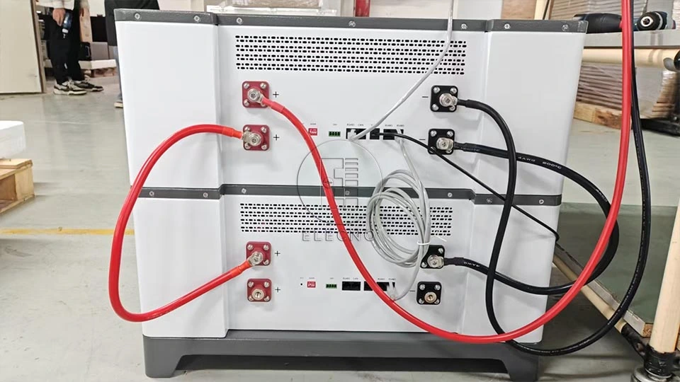 Battery module terminals and connected red and black cables in a factory photograph