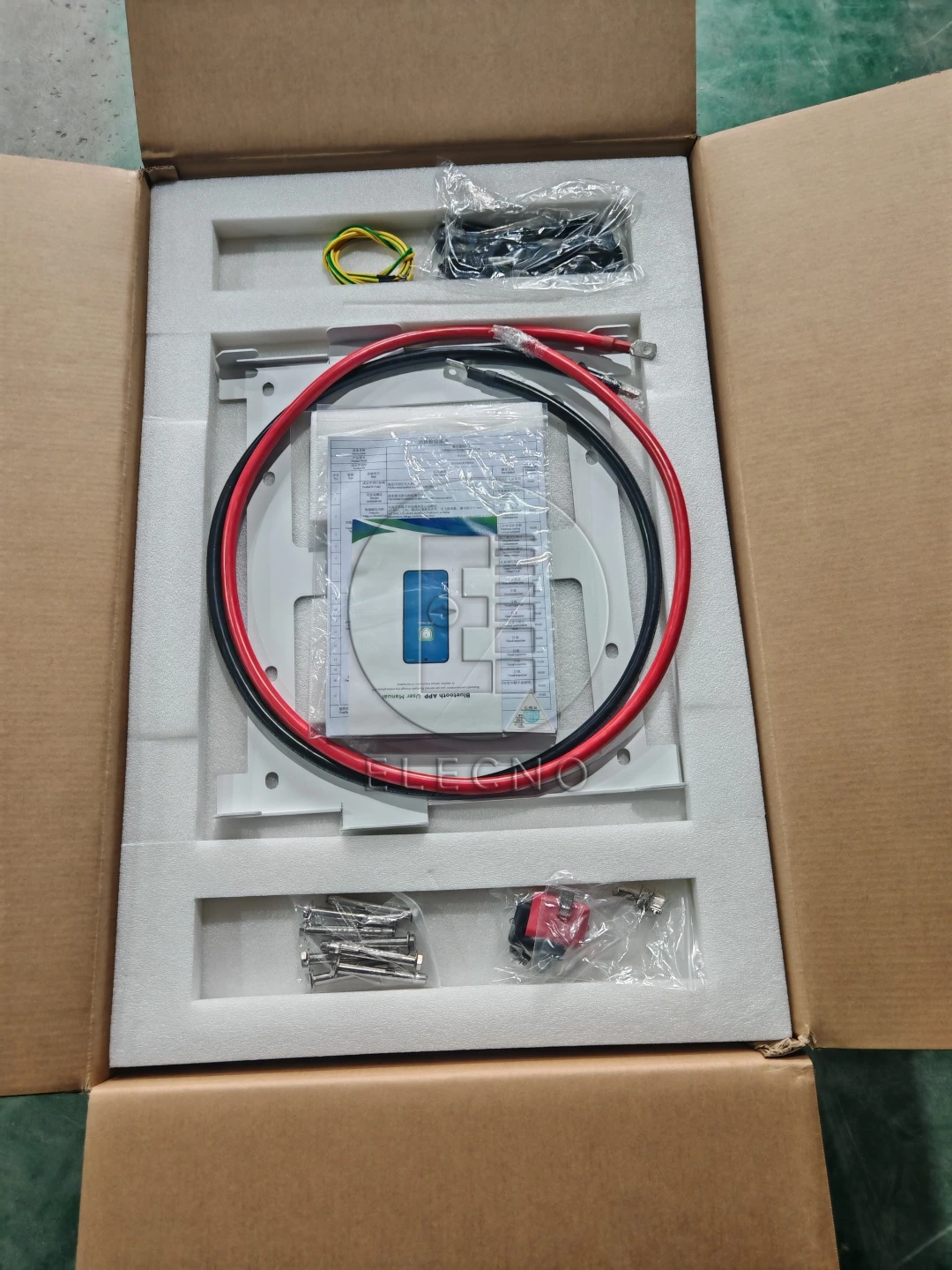 Red and black leads and packaged accessories arranged in protective carton inserts