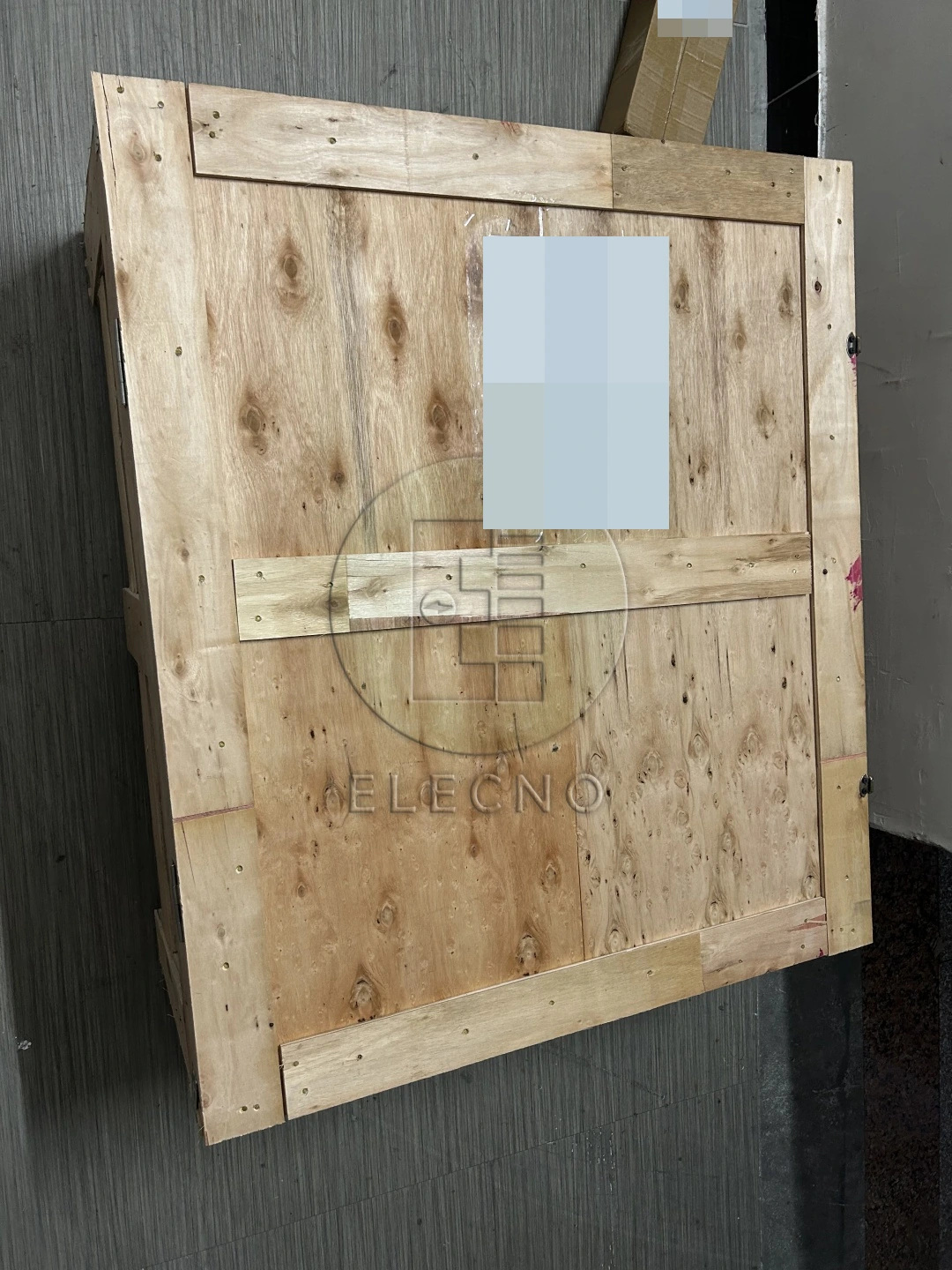 Closed wooden battery shipping crate with customer name and telephone number obscured