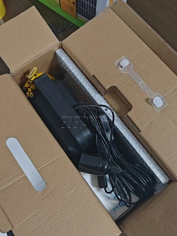 Portable solar lighting equipment and cables inside protective carton packaging