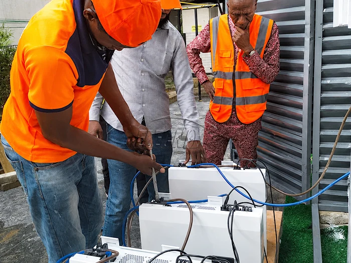 Technicians connecting equipment during Nigeria villa solar project